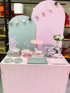 a pink and blue display case with various items on the shelf in front of it