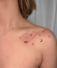 a woman's chest with stars and planets in the sky on her left side