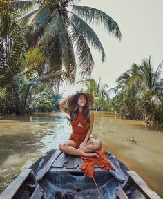 a woman sitting on top of a boat in the water