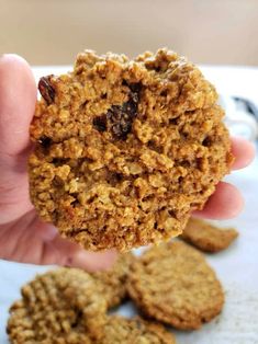 a person holding up a cookie in their hand