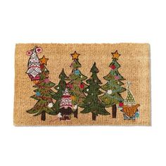 a door mat with three christmas trees on the front and one has an owl in it