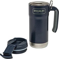 the stanley stainless steel travel mug is shown next to its lid and cup holder, which also has an insulated handle