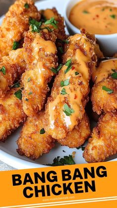 a white plate topped with fried chicken and dipping sauce