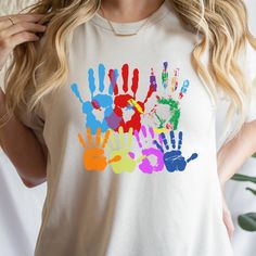 Abstract Handprint Shirt, Helping Hands Shirt, Graphic Tee,  Cute Handprint Shirt, Gift for Her, Friend Gift, Artist Gift, Color Handprint Tee 🎨 Embrace the Artistic Spirit with our Abstract Handprint Shirt! 🖐️ Introducing our Helping Hands Shirt - a captivating Graphic Tee that's not just stylish, but also carries a heartwarming message. This Cute Handprint Shirt is a perfect Gift for Her, celebrating the creativity and friendship that colors our lives. Whether you're an artist looking to show off your passion or searching for a thoughtful present for a creative friend, this Color Handprint Tee is sure to make a lasting impression. Its abstract design captures the essence of imagination, making it a unique and cherished Artist's Gift. Let the vibrant colors and artistic touch of this Ab Fun Multicolor Printed T-shirt, Multicolor Funny Print Graphic Tee, Multicolor Graphic Tee With Funny Print, Fun Multicolor Shirt With Funny Print, Multicolor Graphic Tee With Custom Print, Multicolor Custom Print Graphic Tee, Multicolor Custom Print Graphic Tee Shirt, Multicolor Crew Neck Shirt With Printing, Colorful Printed Cotton T-shirt