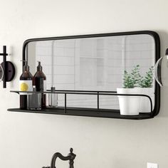 a bathroom sink sitting under a mirror next to a faucet and soap dispenser