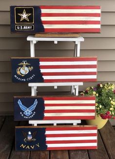 three patriotic wooden signs are stacked on top of each other