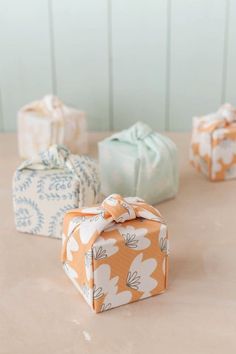 four wrapped presents sitting on top of a table