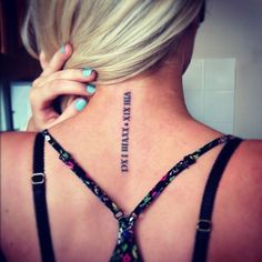 the back of a woman's neck has a tattoo on it that reads,