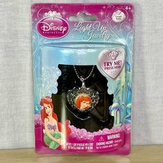 the little mermaid necklace is packaged in its package for $ 3 99 at toys r us