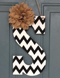 a black and white chevroned door hanger with a burlock flower