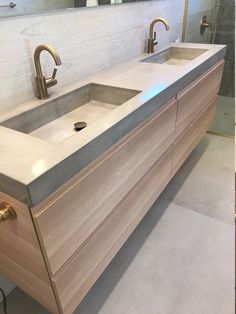 a bathroom sink with two faucets on the side and a mirror above it