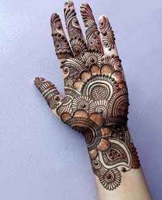 a hand with henna designs on it