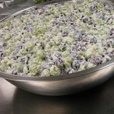 a large metal pan filled with blueberries and celery on top of a table