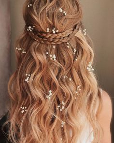 a woman with long blonde hair wearing a braid and flowers in it's hair