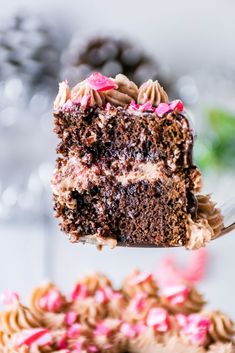 a piece of chocolate cake with pink sprinkles being lifted by a fork