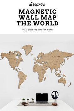 a white desk with a wooden world map on it and the words diy magnetic wall map