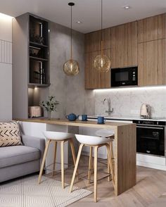 a kitchen with two stools next to an island in the middle of the room