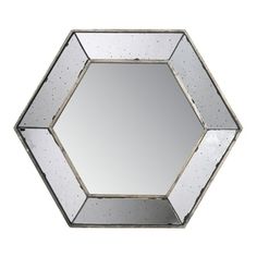 an octagonal mirror is shown with silver paint on the edges and one side has a hexagonal design