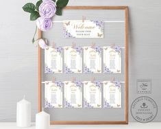 wedding seating chart with purple flowers and greenery on the table next to a candle