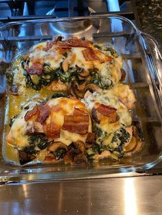 two casseroles with bacon, spinach and cheese in a glass dish on top of a stove