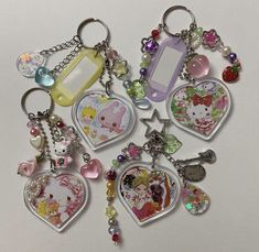 several different key chains with charms attached to them