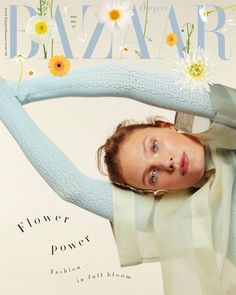 a woman is posing on the cover of bazaar magazine, with flowers in her hair