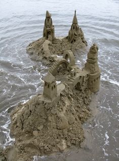 sand castle made to look like waves coming in from the ocean