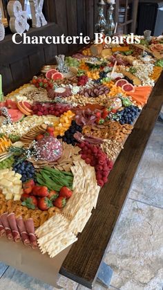 a long table covered with lots of different types of food on top of each other