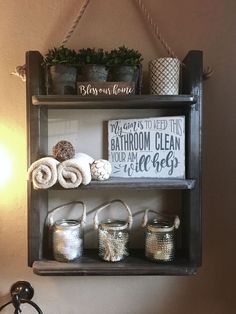 a shelf with towels and other items on it next to a wall mounted sign that says bathroom clean