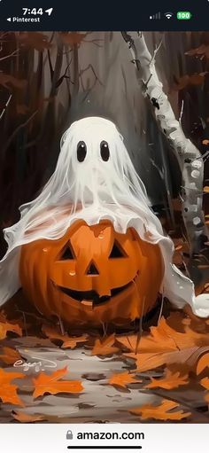 an image of a halloween pumpkin in the woods with ghost on it's head