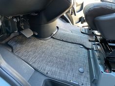 the interior of a car with grey carpet