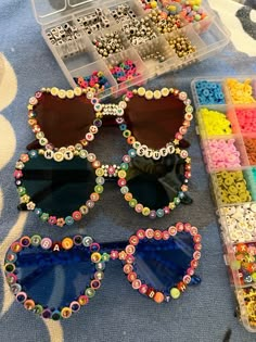 two pairs of sunglasses with colorful beads on the bottom and one pair is made out of plastic