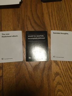 two pamphlets sitting on top of a wooden table