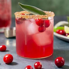 a cranberry shrub cocktail garnished with an olive sprig and sugar