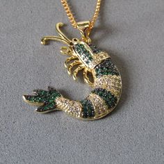 Hello and welcome to  TigerjewellerycoGB  Here we have a beautiful Shrimp Necklace Designed using a stunning 18k Real Gold Long Lasting Plated Emerald Green Micro Pave Cubic Zirconia Shrimp Pendant and I have placed on a Real 18k Gold Plated good quality Handmade 20" curb chain Necklace The size of the pendant is:  28 x 26 x 5x4mm.  Your stunning Necklace will be placed in a clear seal bag, wrapped and sent in a bubble padded envelope. Nickel, Lead and Cadmium Free Postage is FREE 2nd Class Reco Luxury Yellow Gold Necklace With Dragon Design, Luxury Gold Agate Necklace, Gold Necklace With Dragon Design Collectible, Gold Frog Necklace, Yellow Gold Dragon Design Pendant Jewelry, Green Necklace, Stunning Necklace, Micro Pave, Real Gold