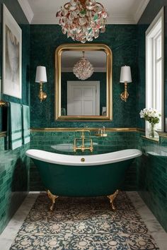 a bathroom with green walls, gold fixtures and a claw foot tub in the center