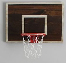 a basketball hoop mounted to the side of a wooden wall