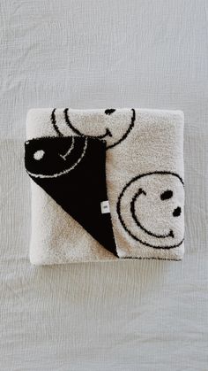 a black and white towel with two faces on it