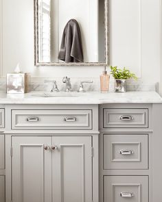 a bathroom vanity with two sinks and a large mirror