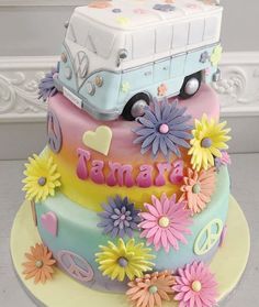 a birthday cake decorated with flowers and a vw bus