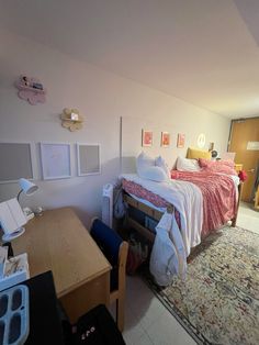 a bed room with a neatly made bed and a desk