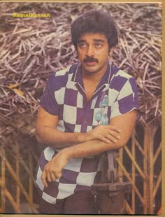 an old photo of a man with a moustache standing in front of straw bales