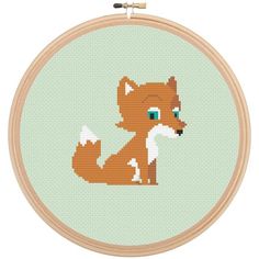 a cross stitch pattern with a cute little fox on it's face, sitting in front of a green background