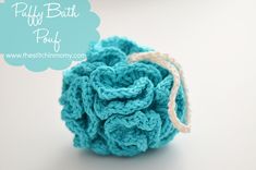 a blue crocheted ball sitting on top of a white table