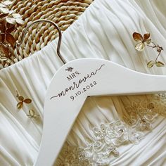 a wedding dress hanger with the names of the bride and groom