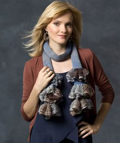 a woman is posing for a photo with her scarf around her neck