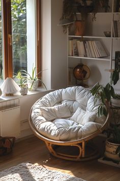 a living room filled with lots of furniture next to a book shelf and window sill