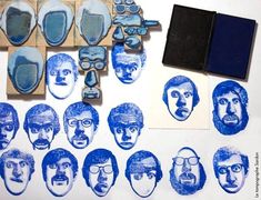 some blue and white images are being used to make rubber stamps on the paper,