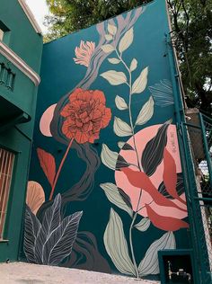 a mural on the side of a building with flowers and leaves painted all over it