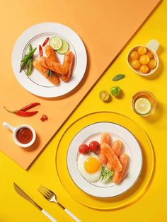 two white plates topped with food next to silverware and utensils on a yellow table